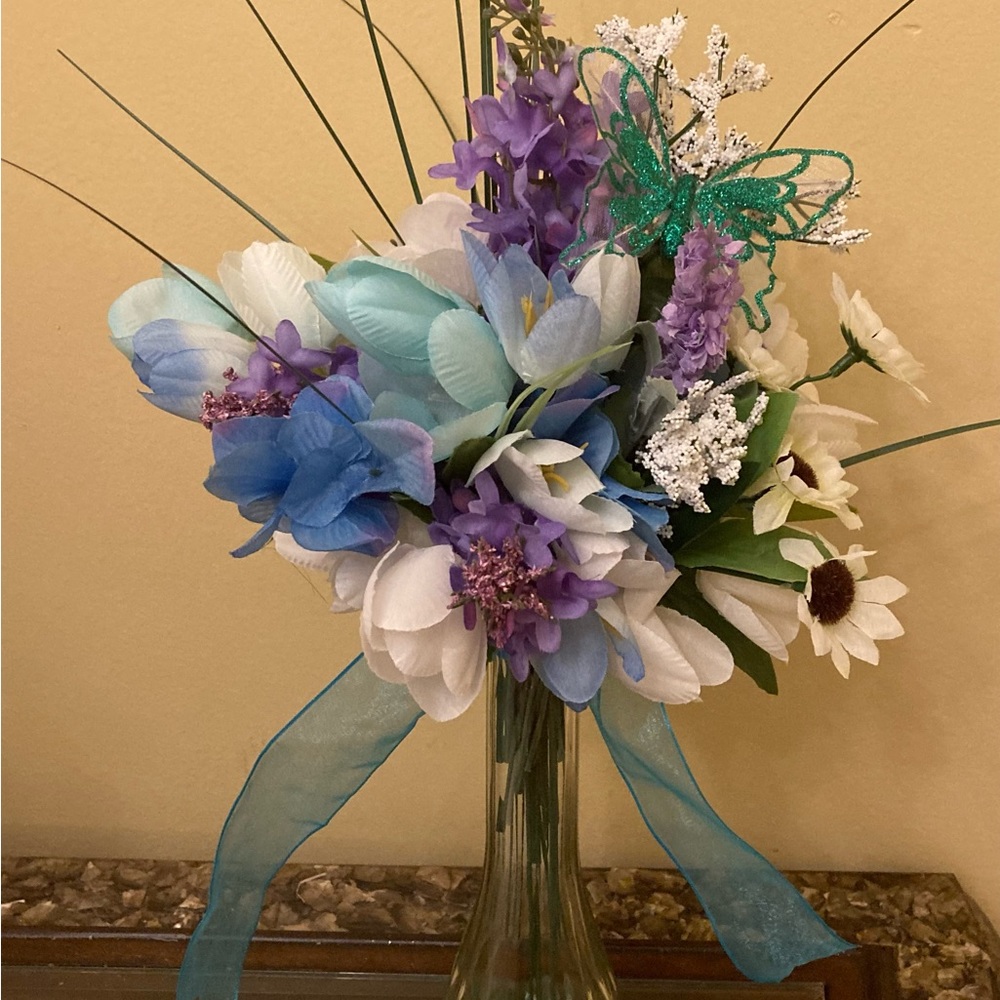 Beautiful Blue vase of flowers with a Blue Butterfly Accent.